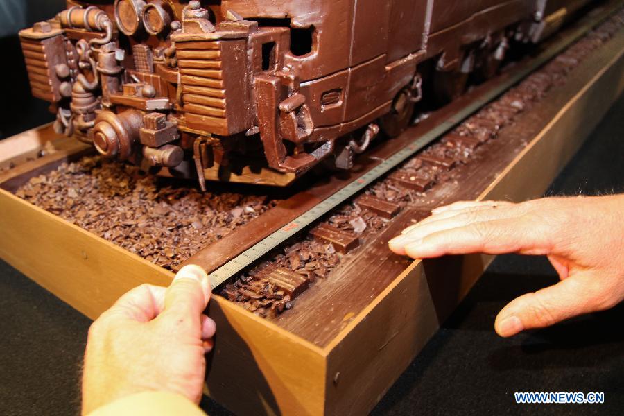 The world's longest chocolate structure on Guinness World Records, made by artist Andrew Farrugia of Malta, is displayed in Brussels November 19, 2012. The chocoloate train, which took 784 hours of labour to create, measures 34.05 meters in total length and was prepared with 1285 kg of Belgian chocolate. (Xinhua/Yan Ting) 