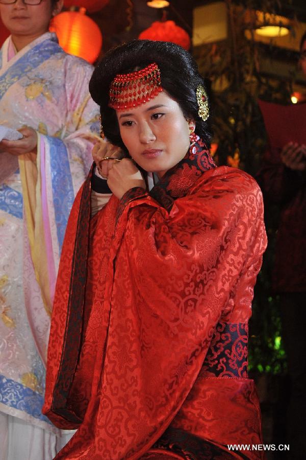 Chen Yuanyuan, the bride, attends a ceremony in which she and her groom Peng Yong officially get married during a traditional Chinese wedding in Guiyang, capital of southwest China's Guizhou Province, Nov. 19, 2012. The traditional Chinese wedding, pursuant to the etiquettes of the Zhou Dynasties (1046-256BC), sees a resurgence in recent years as the sense of identity grows among modern Chinese couples. (Xinhua/Ou Dongqu) 
