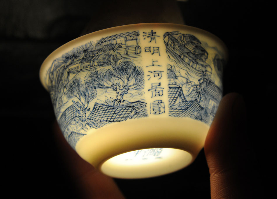 Photo taken on March 8, 2012 shows the tea cup "Riverside Scene at the Qingming Festival" painted by Liu Zhen in Jingdezhen of east China's Jiangxi Province. Usually a set of tea-things will take the painter more than a month to finish. (Xinhua/Zhou Ke)