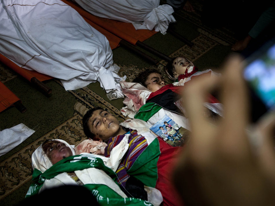 Four children killed in airstrikes are to be buried in the Gaza Strip on Nov. 19, 2012. (Xinhua/Chen Xu)