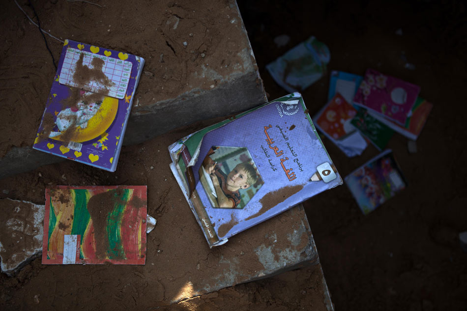 Books of UN Relief and Works Agency for Palestine Refugees in the Near East (UNRWA) are seen in a Palestinian house destroyed during an Israeli air strike in Gaza City, Nov. 20, 2012. Hamas-run Ministry of Health said the death toll since Wednesday in the Gaza Strip has climbed to 130 and more than 1,000 people were wounded in the ongoing Israeli aerial operation on the coastal enclave. (Xinhua/Chen Xu)