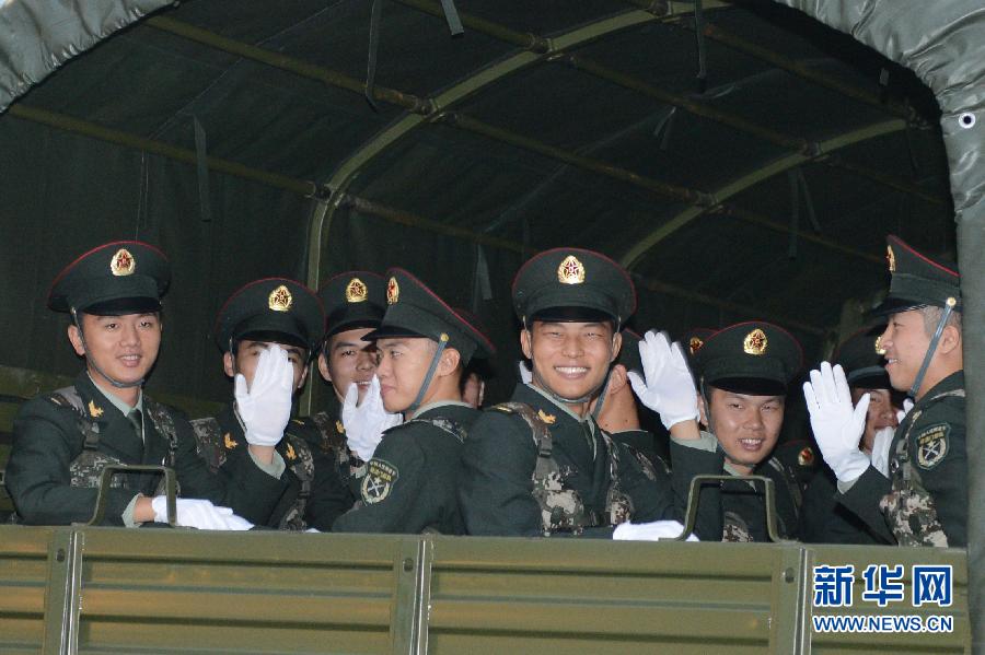 The soldiers who will leave Macao after the rotation bid farewell on a military motor lorry on the early morning of Nov. 20, 2012. The Macao Garrison of the Chinese People's Liberation Army (PLA) successfully finished the 13th rotation yesterday morning. (Xinhua/Zhang Jinjia)