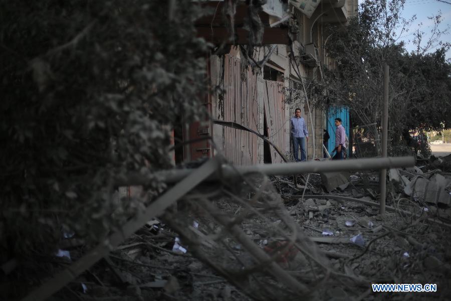 Palestinians inspect the destroyed compound of the internal security ministry in Gaza City after it was targeted by an overnight Israeli air strike on Nov. 21, 2012. (Xinhua/Wissam Nassar) 