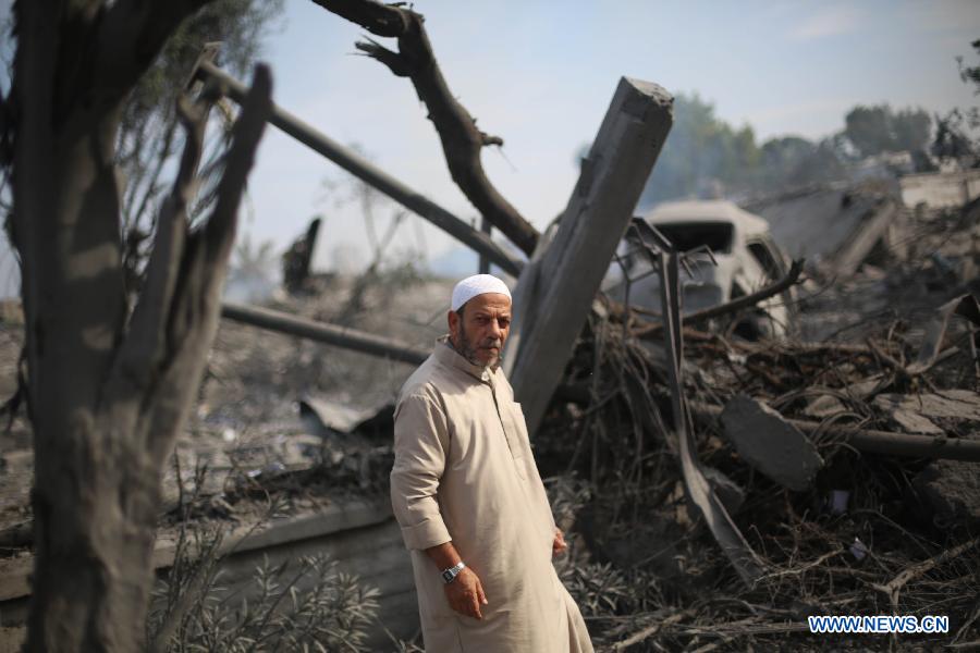 A Palestinian man inspects the destroyed compound of the internal security ministry in Gaza City after it was targeted by an overnight Israeli air strike on Nov. 21, 2012. (Xinhua/Wissam Nassar) 