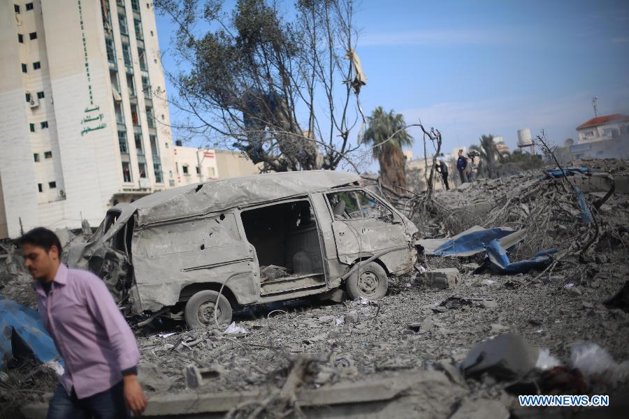A Palestinian man inspects the destroyed compound of the internal security ministry in Gaza City after it was targeted by an overnight Israeli air strike on Nov. 21, 2012. (Xinhua/Wissam Nassar) 
