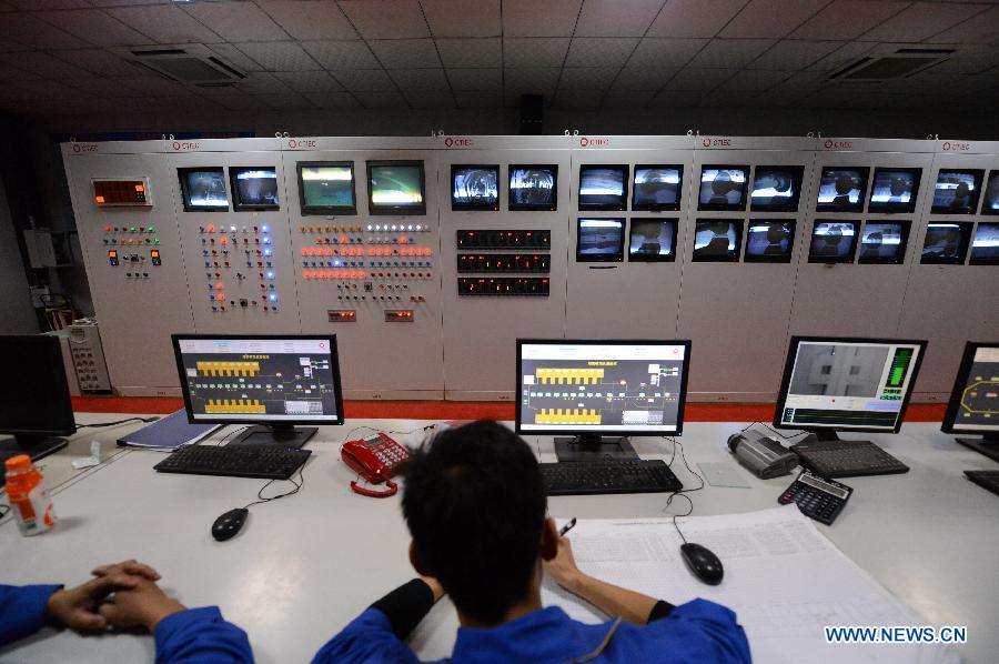 Workers observe monitors of the production line in Hongyu energy company in Zhangshu, east China's Jiangxi Province, Nov. 22, 2012. The company has invested 350 million yuan (56.1 million dollars) and built the largest energy efficiency glass production line in China. (Xinhua/Zhou Mi) 