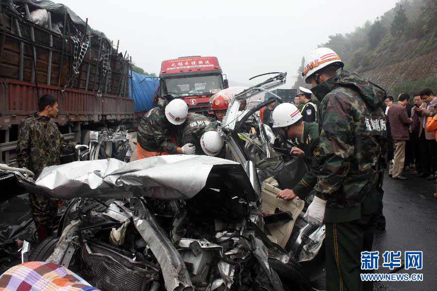 Rescuers work at the scene of a vehicle pileup on the Shenyang-Haikou Expressway in Fuding, southeast China's Fujian Province, Nov. 22, 2012. Five people have died and two others were injured in a pileup involving five vehicles in the Fuding section of the Shenyang-Haikou Expressway on Thursday morning. The two injured people were carrying slight injuries and sent to hospital. (Xinhua/Huang Jianhong)