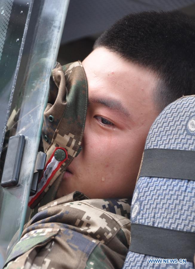 A new military recruit looks out of window as he sheds tears before leaving for southwest China's Tibet Autonomous Region in Yuechi County, southwest China's Sichuan Province, Nov. 21, 2012. A total of 27 new soldiers in Yuechi have headed to Tibet region ahead of schedule so as to adapt to plateau climate. (Xinhua/Hu Zuobin) 