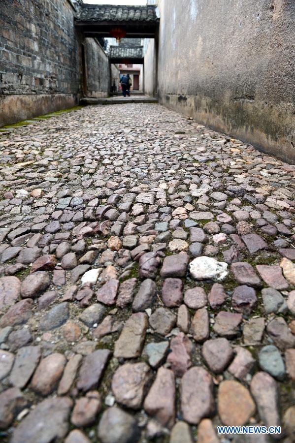 Photo taken on Nov. 20, 2012 shows the road paved by cobbles inside a walled village in Xinwei Village of Longnan County in Ganzhou City, east China's Jiangxi Province. The Gannan (southern Jiangxi Province) Hakka walled villages, a special architectural type, was included into China's World Cultural Heritage Tentative List on Nov. 17, 2012. The whole structure of the building resembles a small fortified city, containing halls, storehouses and living areas. It is regarded as the "cradle of Hakka". According to official statistics, there are over 600 such buildings in Gannan at present. (Xinhua/Song Zhenping) 