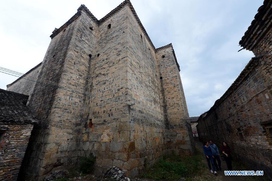 Photo taken on Nov. 22, 2012 shows a walled village in Chebu Village of Dingnan County in Ganzhou City, east China's Jiangxi Province. This clay building was built in 1786, covering an area of 1,300 square meters. The Gannan (southern Jiangxi Province) Hakka walled villages, a special architectural type, was included into China's World Cultural Heritage Tentative List on Nov. 17, 2012. The whole structure of the building resembles a small fortified city, containing halls, storehouses and living areas. It is regarded as the "cradle of Hakka". According to official statistics, there are over 600 such buildings in Gannan at present. (Xinhua/Song Zhenping) 