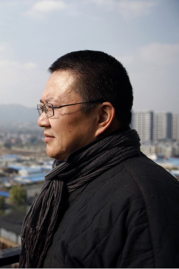 Wang Shu overlooks the city while standing on a building at the Xiangshan campus of the China Academy of Art in Hangzhou, capital of east China's Zhejiang Province, Dec. 9, 2011. (Xinhua/Cui Xinyu)