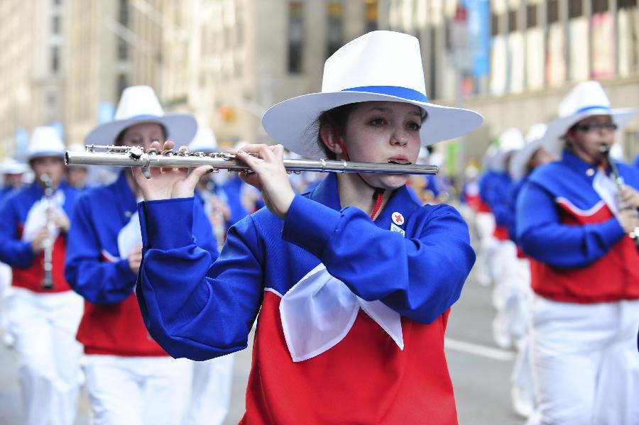 A brass band walks on the street in the 86th Macy's Thanksgiving Day Parade in New York, the United States, Nov. 22, 2012. More than three million people gather along the street on Thursday, to attend the annual Macy's parade which began in 1924. (Xinhua/Deng Jian)