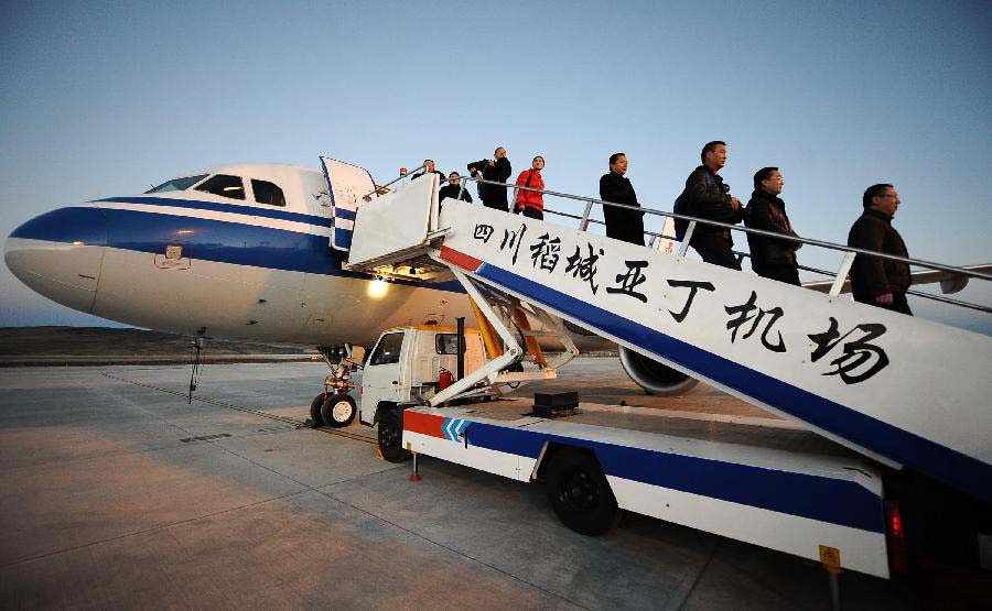 Passengers get off the test flight at the Daochengyading Airport in Daocheng County of the Tibetan Autonomous Prefecture of Garze, southwest China's Sichuan Province, Nov. 23, 2012. The first test flight of the airport successfully landed Friday. With the height of 4,411 meters above sea level, the Daochengyading Airport becomes the highest civil airport in the world. (Xinhua/Xue Yubin) 
