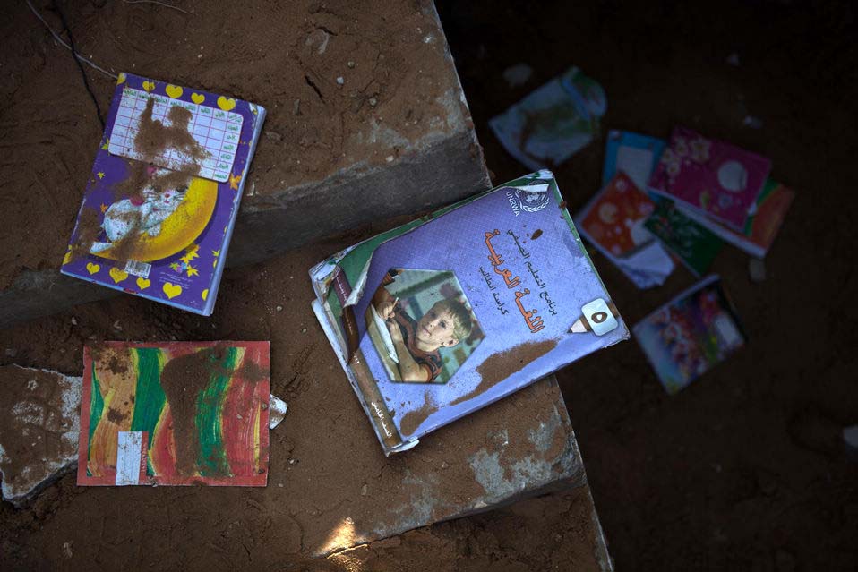 Books of UN Relief and Works Agency for Palestine Refugees in the Near East (UNRWA) are seen in a Palestinian house destroyed during an Israeli air strike in Gaza City, Nov. 20, 2012.(Xinhua/Chen Xu)
