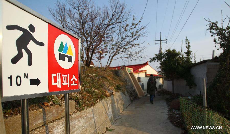 A man walks past a sanctuary on Yeonpyeong island, South Korea, Nov. 23, 2012. A memorial service was held on South Korea's Yeonpyeong island Friday as the country marked the second anniversary of the shelling on the island by the Democratic People's Republic of Korea (DPRK). (Xinhua/Yao Qilin)  