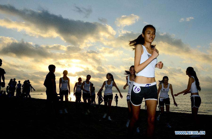 Contestants of the New Silk Road Model Contest participate in an outdoor show in Sanya, south China's Hainan Province, Nov. 22, 2012. The finals will be held on Nov. 30. (Xinhua/Jin Liangkuai)