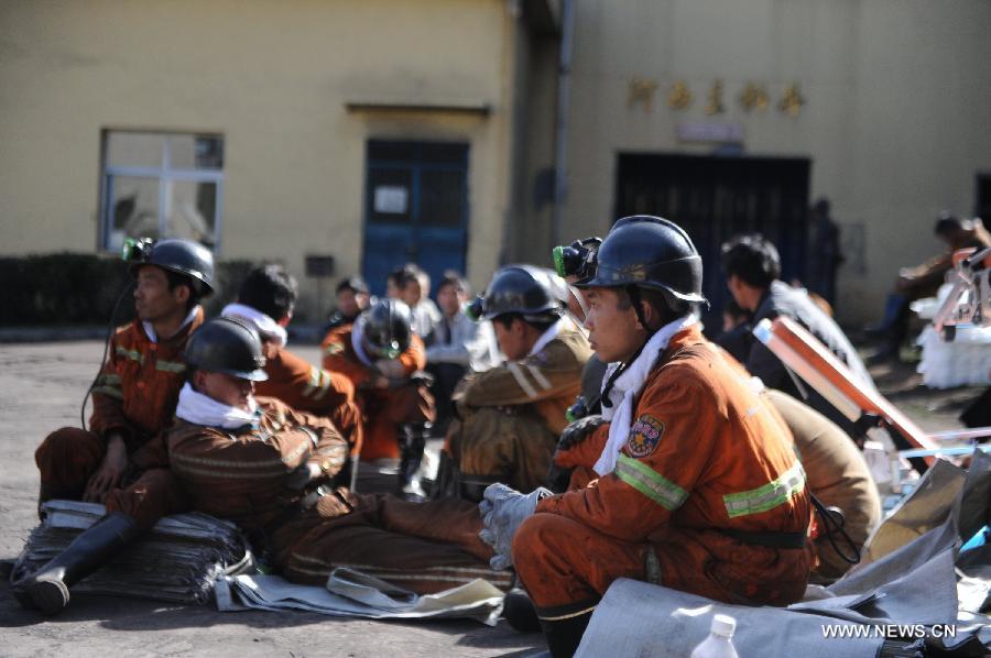 Rescuers take a rest before entering the shaft to continue rescue work at the Xiangshui Coal Mine in Panxian County of Liupanshui City, southwest China's Guizhou Province, Nov. 25, 2012. Nineteen miners were confirmed dead, and four others remain trapped after a coal-gas outburst hit the Xiangshui Coal Mine at 10:55 a.m. on Saturday.(Xinhua/Tao Liang) 