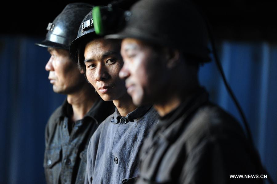 Miners wait at the entrance of the Xiangshui Coal Mine in Panxian County of Liupanshui City, southwest China's Guizhou Province, Nov. 25, 2012. Nineteen miners were confirmed dead, and four others remain trapped after a coal-gas outburst hit the Xiangshui Coal Mine at 10:55 a.m. on Saturday.(Xinhua/Tao Liang) 