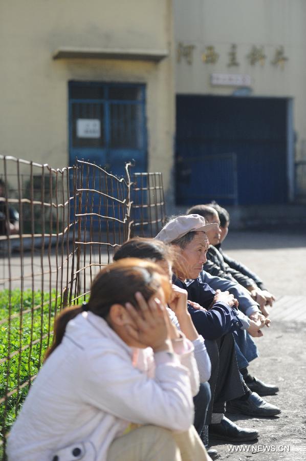 Relatives of trapped miners wait at the entrance of the Xiangshui Coal Mine in Panxian County of Liupanshui City, southwest China's Guizhou Province, Nov. 25, 2012. Nineteen miners were confirmed dead, and four others remain trapped after a coal-gas outburst hit the Xiangshui Coal Mine at 10:55 a.m. on Saturday.(Xinhua/Tao Liang) 