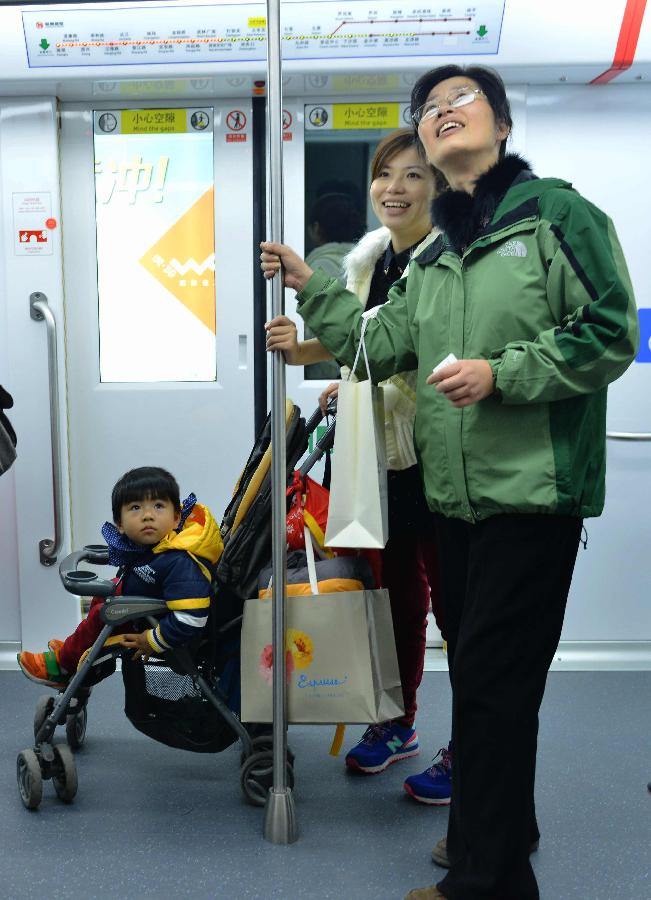 Passengers are seen on a train of Hangzhou Subway Line 1 in Hangzhou, capital of east China's Zhejiang Province, Nov. 24, 2012. Hangzhou Subway Line 1, the first subway in Zhejiang covering a distance of 47.97 kilometers, was put into a trial operation on Saturday after five years of construction. (Xinhua/Long Wei)  