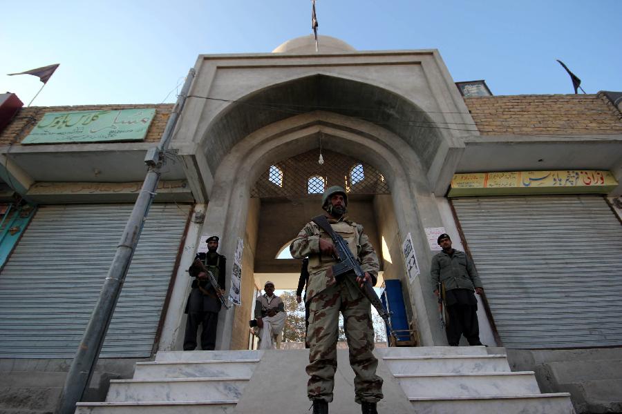 Pakistani soldiers stand guard on a street during an Ashura procession in southwest Pakistan's Quetta on Nov. 25, 2012. At least five people were killed and 83 others injured when a blast hit a Shia Muslim procession to mark Muharram, the first month of the Islamic calendar, in Pakistan's northwest district of Dera Ismail Khan on Sunday morning, said a senior official. (Xinhua Photo/Iqbal Hussain) 