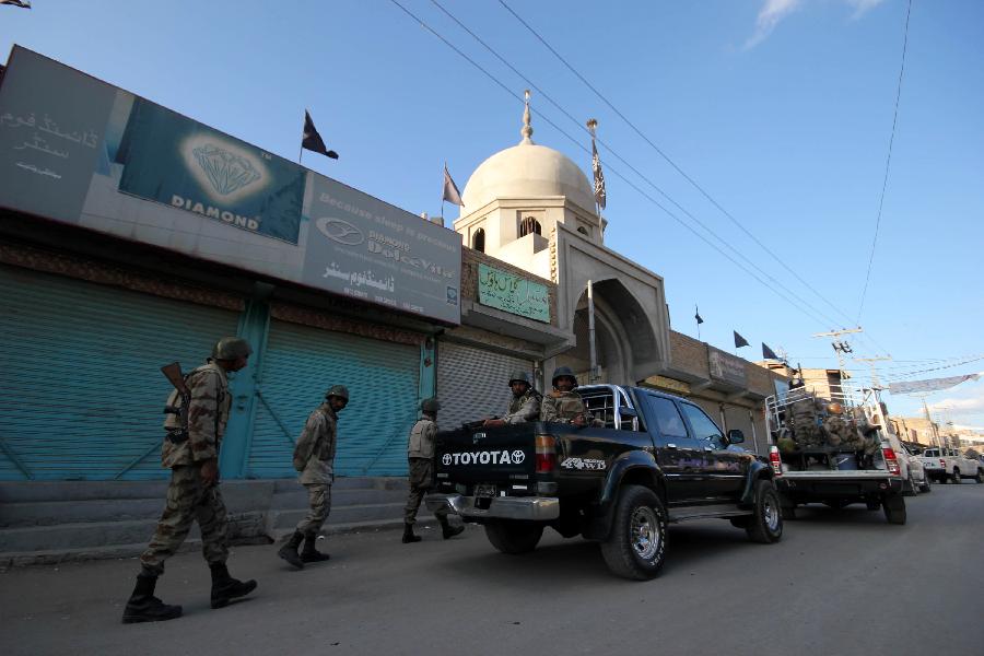 Pakistani soldiers stand guard on a street during an Ashura procession in southwest Pakistan's Quetta on Nov. 25, 2012. At least five people were killed and 83 others injured when a blast hit a Shia Muslim procession to mark Muharram, the first month of the Islamic calendar, in Pakistan's northwest district of Dera Ismail Khan on Sunday morning, said a senior official. (Xinhua Photo/Iqbal Hussain) 