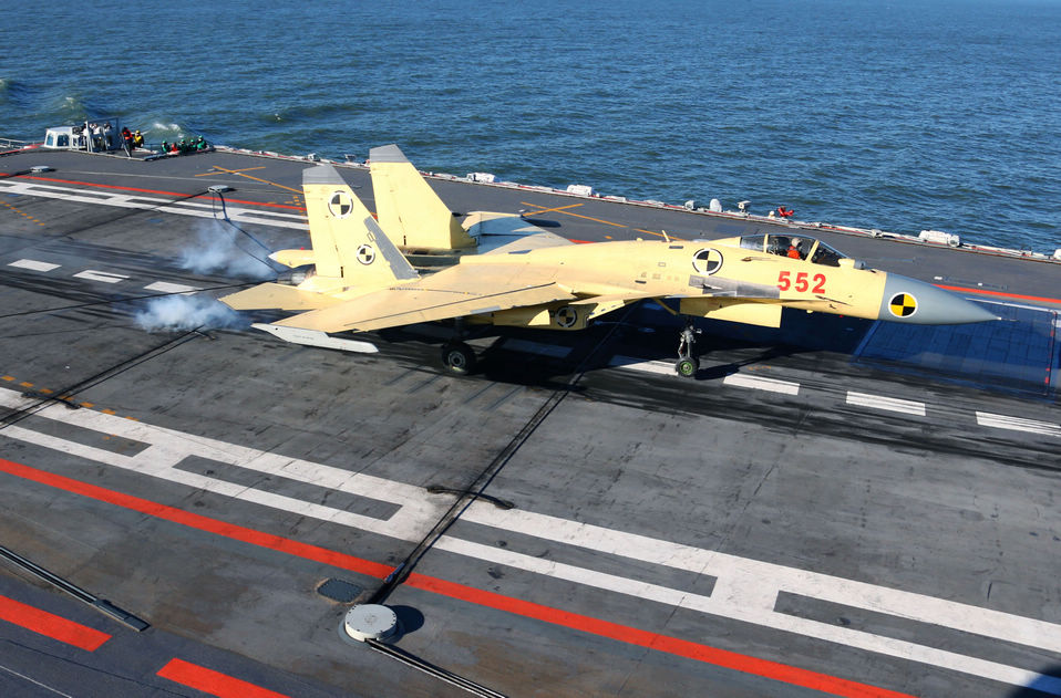 A J-15 fighter jet is slowed by an arresting device as it lands on the Liaoning  aircraft carrier in a recent training exercise in Dalian, Liaoning province.(Xinhua/Cha  Chunming)