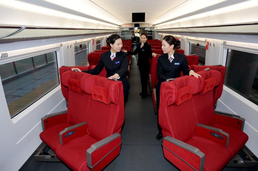 Railway attendants make up a business car of a CRH bullet train in Shenyang, capital of northeast China's Liaoning Province, Nov. 26, 2012. The Shenyang Railway Bureau has launched training programmes for bullet train attendants who will be working on the Harbin-Dalian High-Speed Railway, scheduled to open on Dec. 1, 2012. The 921-km Harbin-Dalian High-Speed Railway is the first rail line in China's freezing high-latitude regions. (Xinhua/Zhang Wenkui)