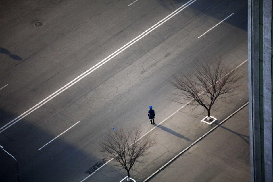 A traffic policeman stands on street in downtown Pyongyang. (Photo/Xinhua)