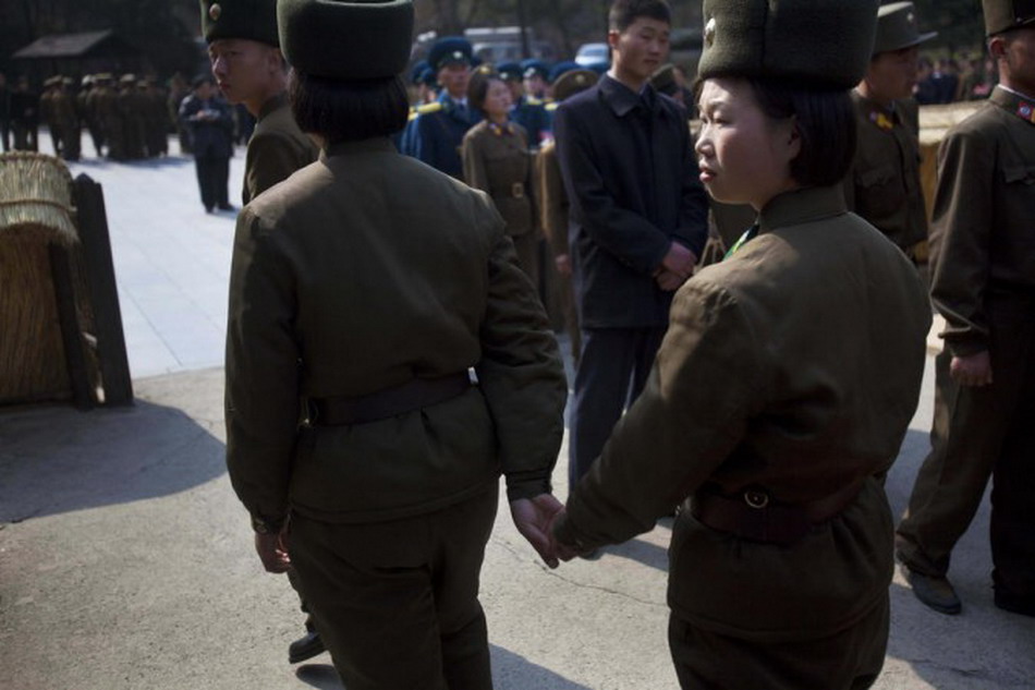 Two traffic policewomen walk hand in hand. (Photo/Xinhua) 