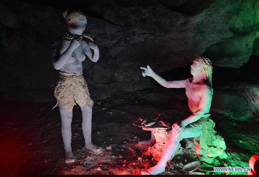 Photo taken on Nov. 26, 2012 shows the sculptures imitating ancient people's life at the Xianren Cave in Dayuan Township of Wannian County, east China's Jiangxi Province. Xianren Cave is the location for historically important finds of prehistoric pottery sherds and rice remains. (Xinhua/Zhou Ke) 