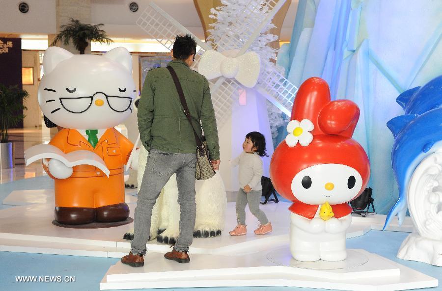 A man and his child visit a Hello Kitty exhibition in the Joy City in east China's Shanghai Municipality, Nov. 26, 2012. The big Hello Kitty exhibition themed on Hello Kitty's exploration in the polar regions would last from Nov. 24, 2012 to Feb. 24, 2013 in Shanghai. (Xinhua/Lai Xinlin) 