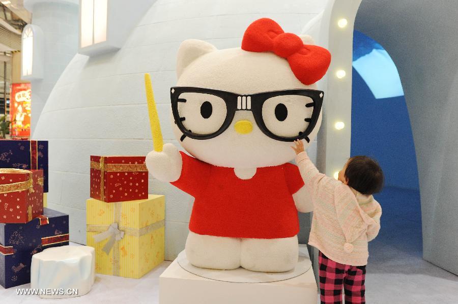 A little girl plays around a red Hello Kitty in the Joy City in east China's Shanghai Municipality, Nov. 26, 2012. A big Hello Kitty exhibition themed on Hello Kitty's exploration in the polar regions would last from Nov. 24, 2012 to Feb. 24, 2013 in Shanghai. (Xinhua/Lai Xinlin) 