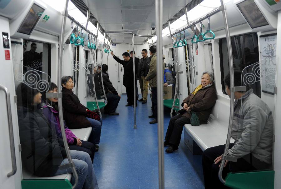 Citizens take a trial ride on the northern section of Subway Line 9 in Beijing, capital of China, Nov. 26, 2012. The northern section of Beijing Subway Line 9, which operates between the National Library and Beijing West Station, is scheduled to open by the end of 2012. The southern section of the 16.45-km subway line is already in service since its opening on Dec. 31, 2011. (Xinhua/Gong Lei) 