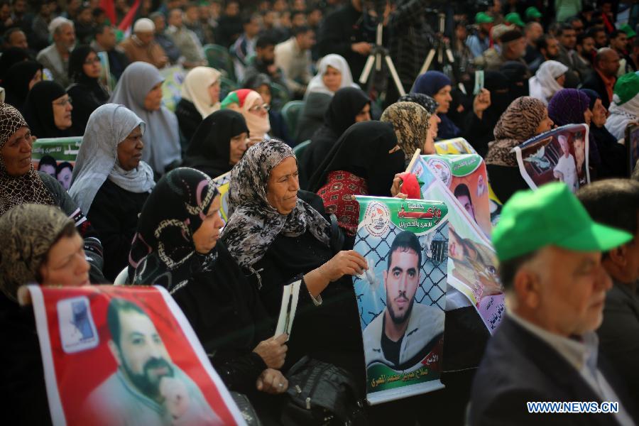 Palestinian women hold posters of Palestinian prisoners during a protest calling for the release of them from Israeli jails and in support of prisoners on hunger strike in front of Red Cross, in Gaza city, on Nov. 26, 2012. Some 4,600 Palestinians prisoners are still in the Israeli prisons. (Xinhua/Wissam Nassar)