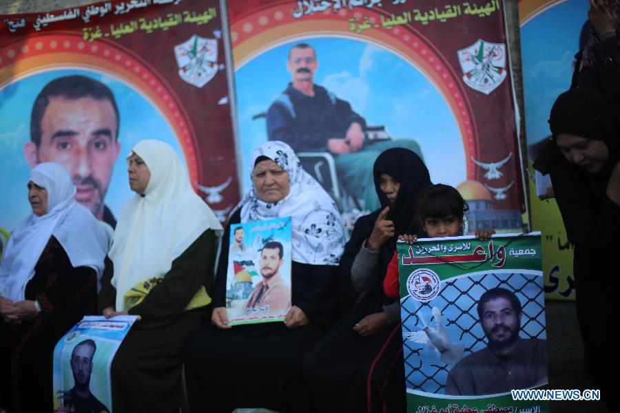 Palestinian women hold posters of Palestinian prisoners during a protest calling for the release of them from Israeli jails and in support of prisoners on hunger strike in front of Red Cross, in Gaza city, on Nov. 26, 2012. Some 4,600 Palestinians prisoners are still in the Israeli prisons. (Xinhua/Wissam Nassar)