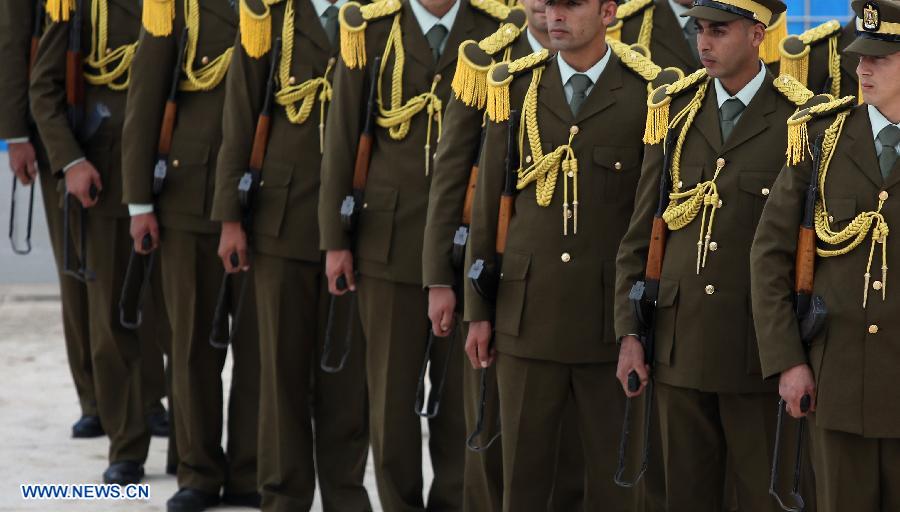 Members of an honour guard stand outside the mausoleum housing late Palestinian President Yasser Arafat, in the West Bank city of Ramallah, on Nov. 27, 2012. Earlier Tuesday, the PNA finalized digging up the remains of Arafat, as Russian, Swiss and French experts took samples of the remains to inspect the reason behind his death. (Xinhua/Ayman Nobani)