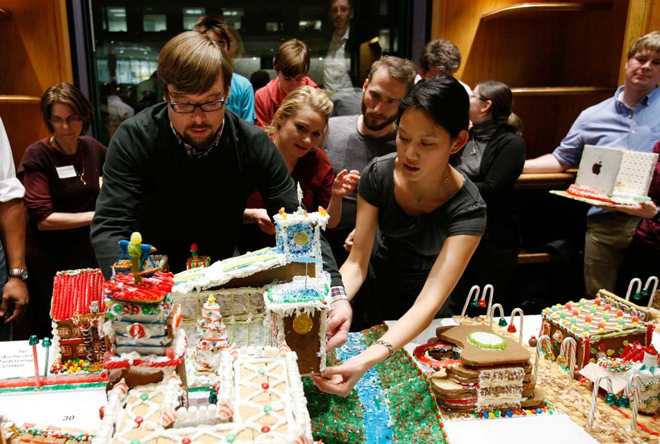 People place self-made “gingerbread house” in “gingerbread village” in Washington D. C., capital of the United States, on Nov. 26, 2012. The “gingerbread village” was proposed to build by an architect in 2006.  Since then, architects and designers in the capital gather annually to build a village composed of gingerbread to celebrate the Christmas. (Xinhua/Fang Zhe)