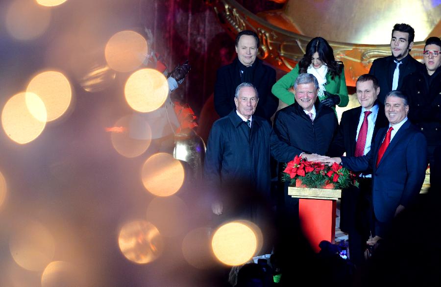 New York City Mayor Michael Bloomberg (1st L Front) attends a ceremony to light up an 80-foot-tall Christmas tree by Rockefeller Center in New York, the United States, on Nov. 28, 2012. Each year a Christmas tree will be lit up by Rockefeller Center to greet upcoming Christmas and New Year. (Xinhua/Wang Lei) 