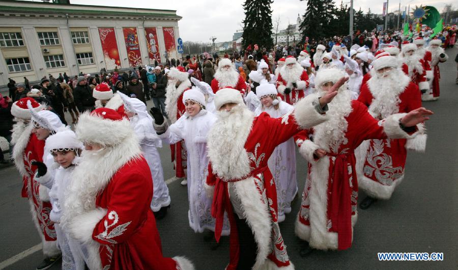 People dressed as Santa Claus march during a Christmas parade in Minsk, Belarus, Dec. 24, 2011. (Xinhua/Sun Ping)