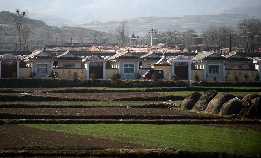 Photo taken on Nov. 28, 2012 shows new houses at Shuangming Village in Huating County, northwest China's Gansu Province. The coal-rich county once suffered from environment degradation due to exploitation of natural resources. Great efforts have been made in recent years to repair the environment, and now the county has turned to be a liveable place with clean air and beautiful gardens. (Xinhua/Zhang Meng)  