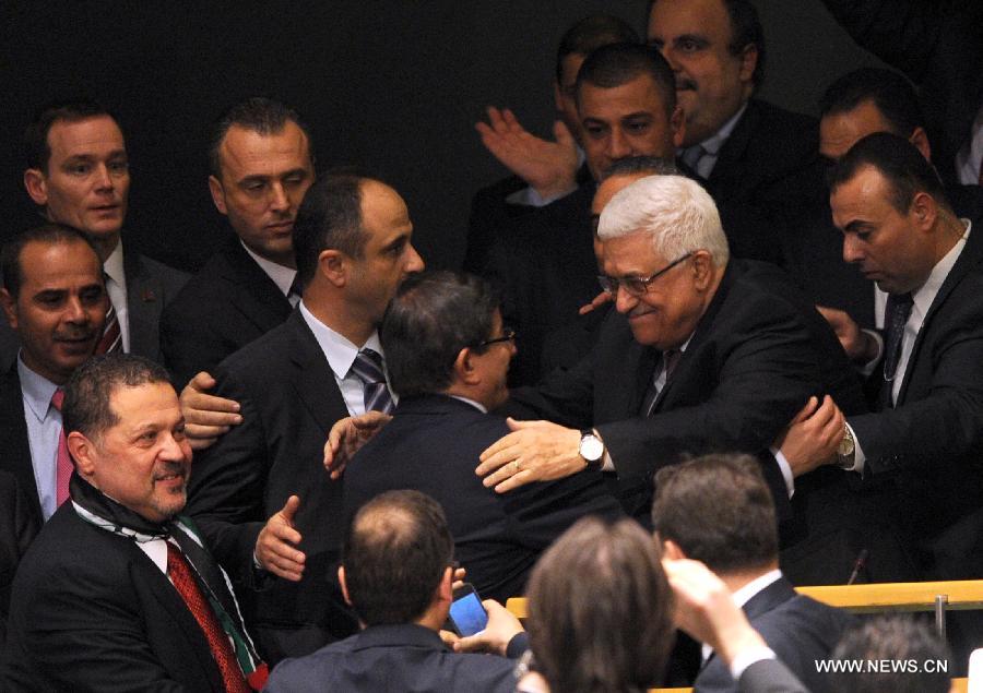 Palestinian President Mahmoud Abbas (2nd R) gets congratulations at the UN General Assembly (UNGA) meeting at the UN headquarters in New York, the United States, on Nov. 29, 2012. The UNGA on Thursday voted overwhelmingly to grant an upgrade of the Palestinians status at the United Nations from "entity" to "non-member state". (Xinhua/Shen Hong)