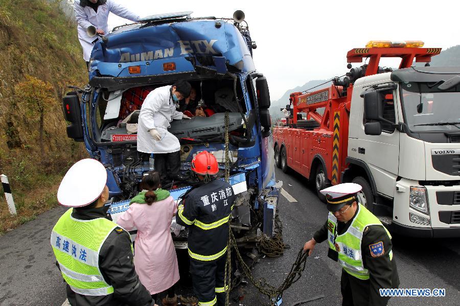 Rescuers work at the scene of a rear-end collision in a section of the Chongqing-Changsha Expressway in Apengjiang Town, Qianjiang District, southwest China's Chongqing Municipality, Nov. 28, 2012.