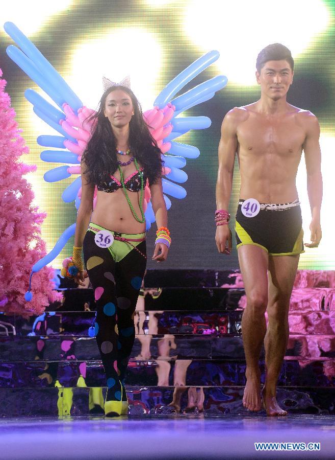 Two models show on the catwalks of a model competition in Sanya, south China's Hainan Province, Nov. 30, 2012. The final of the 20th New Silk Road Model Competition was held here on Friday. (Xinhua/Jin Liangkuai)