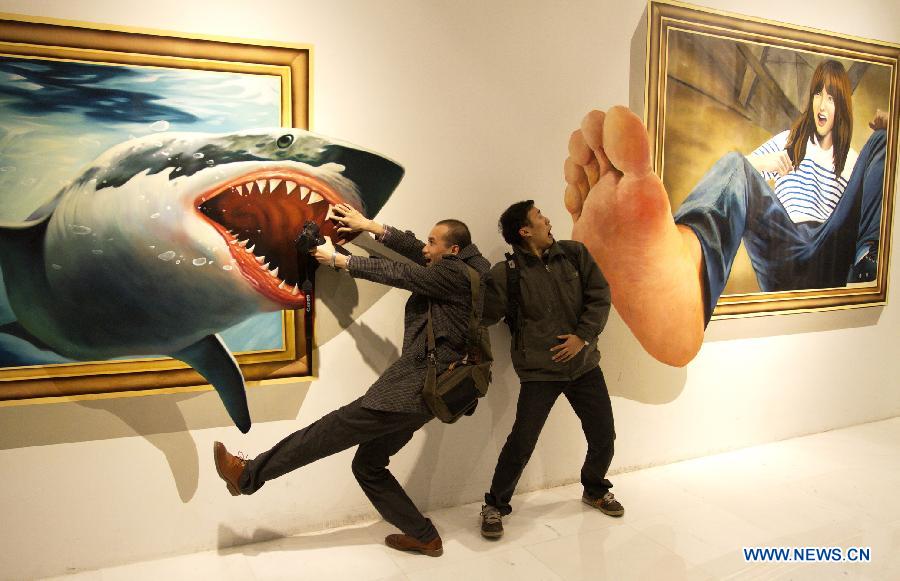 Visitors pose with a three dimensional painting during an exhibition in Tianjin, north China, Dec. 1, 2012. (Xinhua/Wang Qingyan)