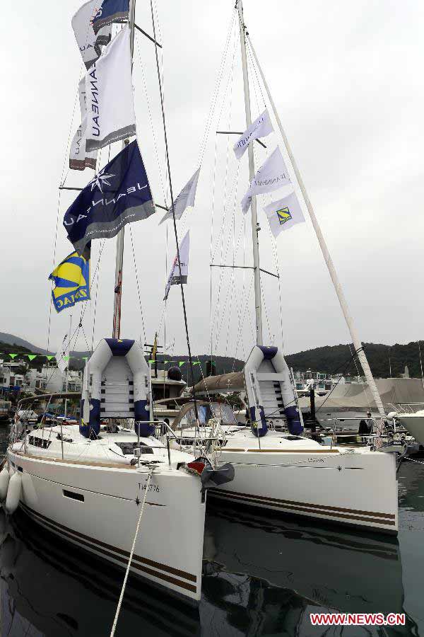 Two yachts are pictured at its booth during Hong Kong International Boat Show 2012 in south China's Hong Kong, Dec. 2, 2012. The boat show closed on Sunday. (Xinhua/Li Peng) 