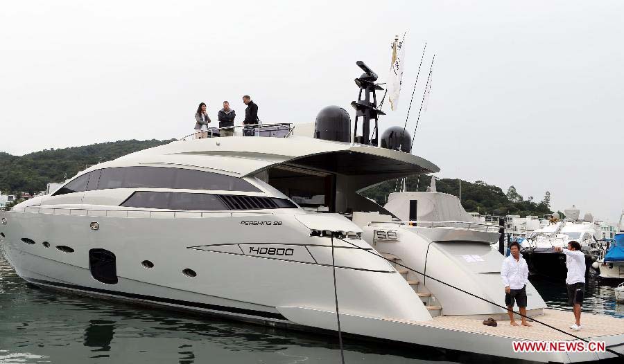 Visitors stand on the deck of a yacht on display at Hong Kong International Boat Show 2012 in south China's Hong Kong, Dec. 2, 2012. The boat show closed on Sunday. (Xinhua/Li Peng) 