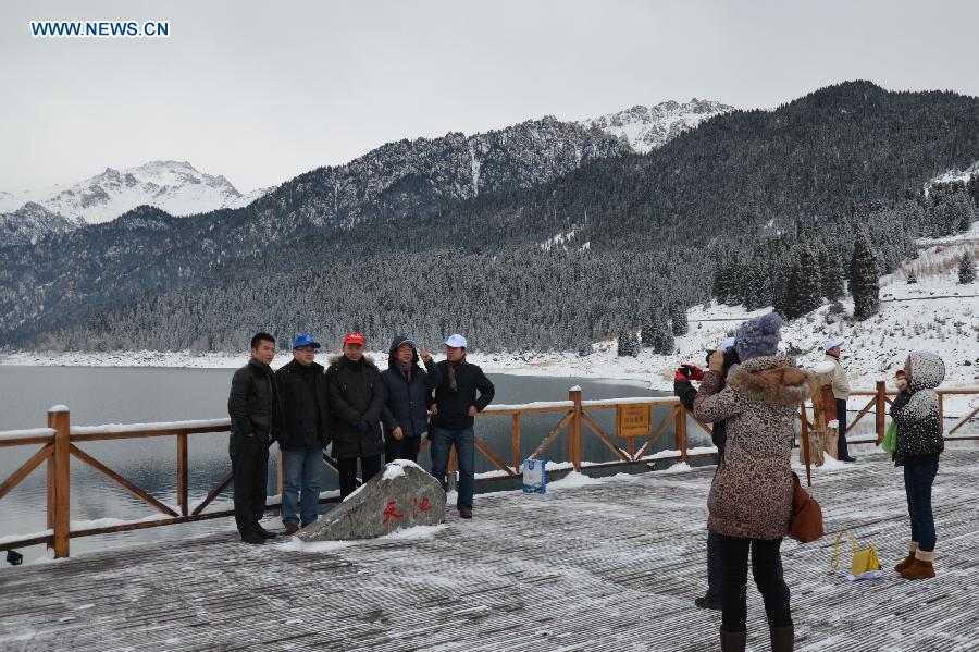 Tourists pose for photos at the Tianchi Scenic Zone in the Tianshan Mountains, northwest China's Xinjiang Uygur Autonomous Region, Dec. 1, 2012. The Tianchi Ice and Snow Festival kicked off at the scenic spot on Saturday. (Xinhua/Yu Tao) 