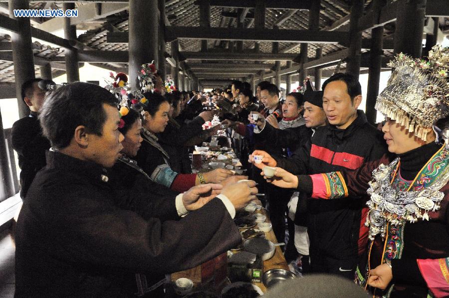 People of the Dong ethnic group attend a feast during a celebration ceremony marking the 100th anniversary of the completion of Chengyang Fengshui Bridge held in Sanjiang Dong Autonomous County, south China's Guangxi Zhuang Autonomous Region, Dec. 1, 2012. (Xinhua/Lai Liusheng) 