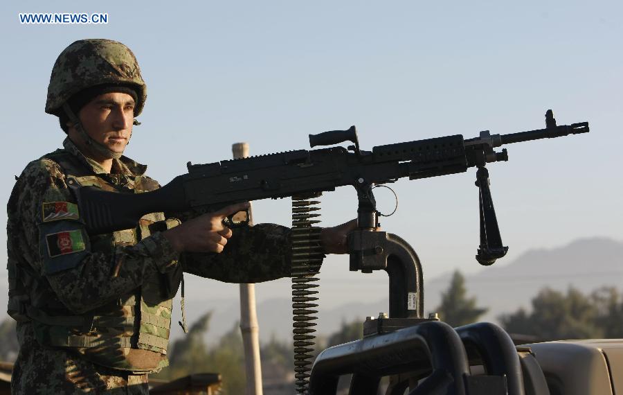 A soldier keeps watch at the site of an attack in Nangarhar Province, Afghanistan, on Dec. 2, 2012. At least 11 people were killed when several Taliban militants armed with suicide vests and weapons stormed an Afghan-NATO base in Jalalabad, the capital city of Afghanistan's eastern province of Nangarhar Sunday morning. (Xinhua/Tahir Safi)